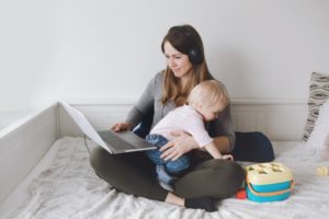 A mother working with a baby: multitasking