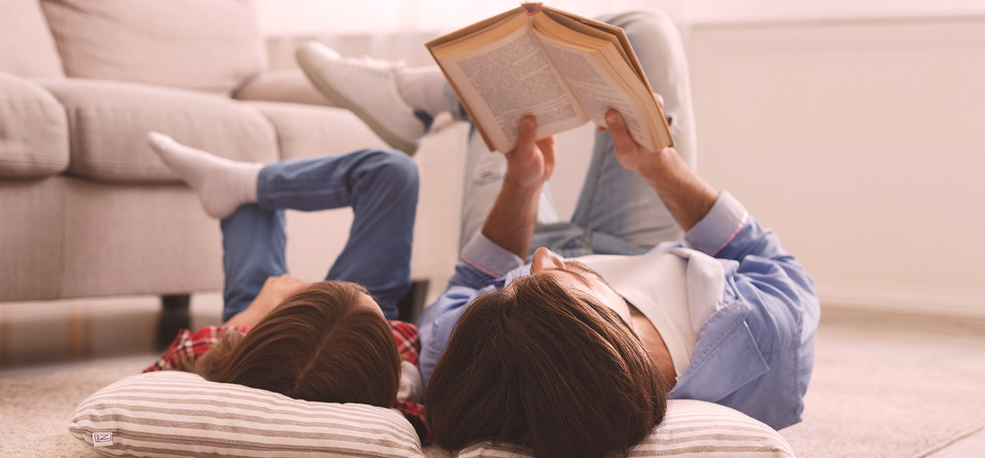 A child and a parent reading a book.