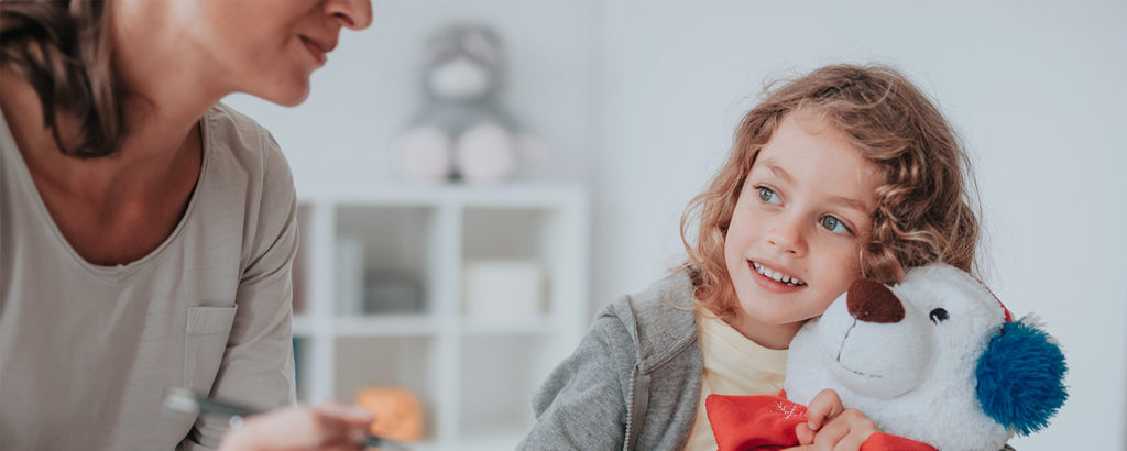 A pre-school boy with a toy and his mom: speech development assessment